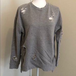 Joe’s ripped gray sweatshirt.